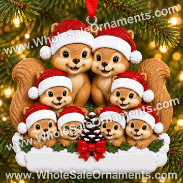 Squirrel family of eight Christmas ornament with pinecone, red bow and blank plaque, hanging on a Christmas tree with warm lights