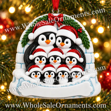 Penguin Family of 9 Igloo Christmas Ornament with blank writing areas, hanging on a Christmas tree with warm golden lights